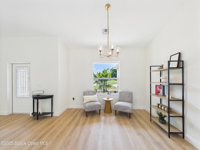 8126 97th Ave, Vero Beach, FL 32967 - sitting room with a chandelier, wood finished floors, and baseboards