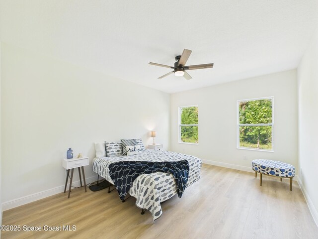 8126 97th Ave, Vero Beach, FL 32967 - bedroom featuring light wood-style flooring, baseboards, and a ceiling fan