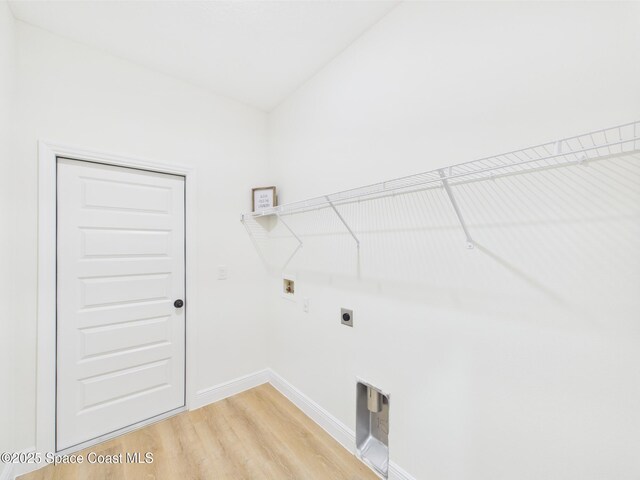 8126 97th Ave, Vero Beach, FL 32967 - laundry room with hookup for a washing machine, hookup for an electric dryer, light wood-type flooring, and baseboards