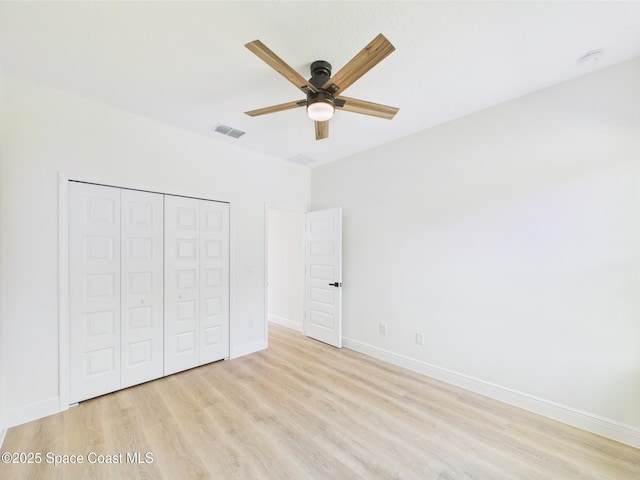 8126 97th Ave, Vero Beach, FL 32967 - unfurnished bedroom with light wood-style floors, a closet, baseboards, and ceiling fan