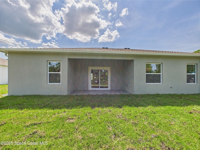 8126 97th Ave, Vero Beach, FL 32967 - rear view of house featuring stucco siding, a yard, and a patio
