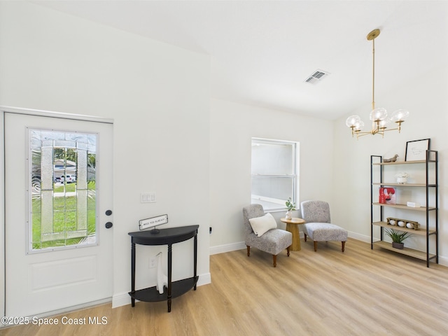 8126 97th Ave, Vero Beach, FL 32967 - sitting room featuring light wood finished floors, a chandelier, and baseboards