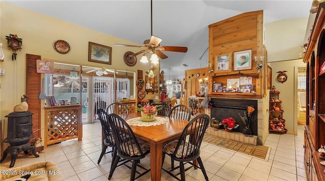 8516 99th Ct, Vero Beach, FL 32967 - dining room featuring a ceiling fan, light tile patterned flooring, high vaulted ceiling, and a fireplace with raised hearth