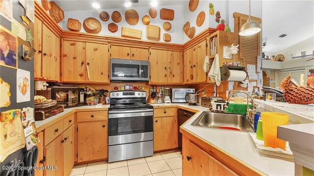 8516 99th Ct, Vero Beach, FL 32967 - kitchen with stainless steel appliances, light tile patterned flooring, light countertops, and lofted ceiling