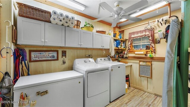 8516 99th Ct, Vero Beach, FL 32967 - washroom with separate washer and dryer, cabinet space, ceiling fan, light wood-style floors, and wood walls