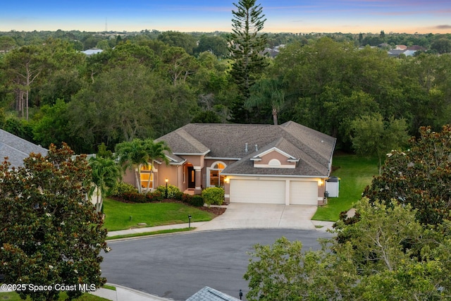 1197 Acappella Dr, Melbourne, FL 32940 - view of front facade featuring an attached garage, stucco siding, driveway, a front yard, and a shingled roof