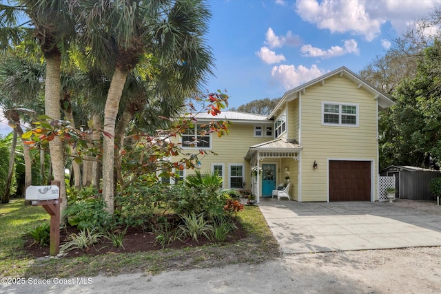 1951 W Sandpiper Rd, Vero Beach, FL 32963 - view of front of property with a garage, concrete driveway, and metal roof