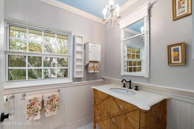 1951 W Sandpiper Rd, Vero Beach, FL 32963 - bathroom featuring a chandelier, wainscoting, healthy amount of natural light, crown molding, and vanity
