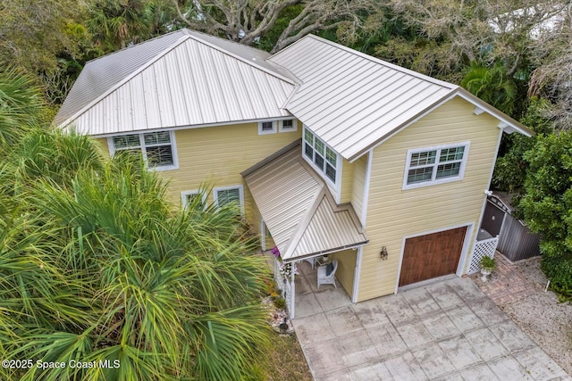 1951 W Sandpiper Rd, Vero Beach, FL 32963 - view of front facade with an attached garage, concrete driveway, and metal roof