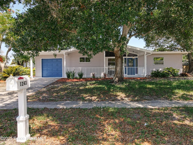 view of front of house with a porch, a garage, and driveway