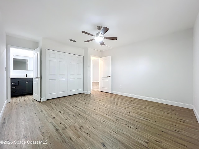 unfurnished bedroom with light wood-style flooring, baseboards, a closet, and ceiling fan