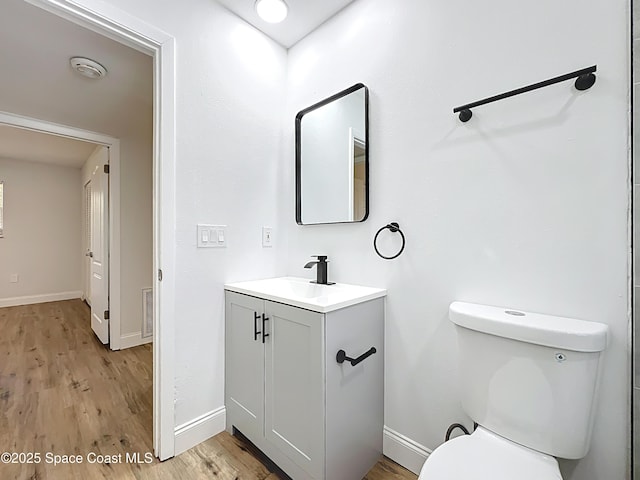 bathroom with baseboards and wood finished floors