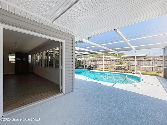 view of pool featuring a fenced backyard, a patio, and a lanai