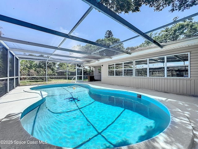 outdoor pool with a lanai and a patio