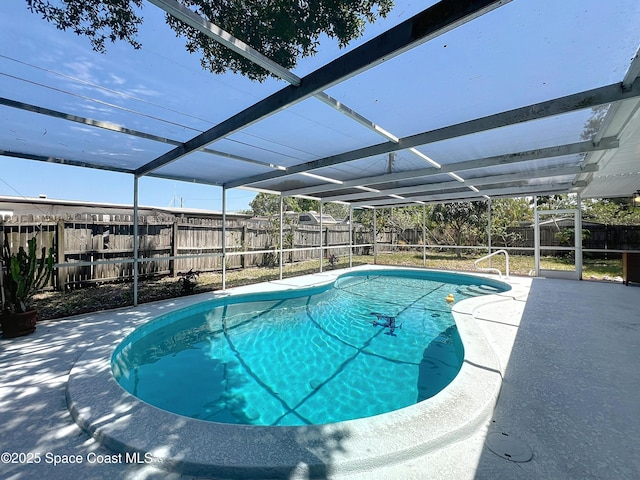 view of pool featuring a fenced backyard, a patio area, and a lanai