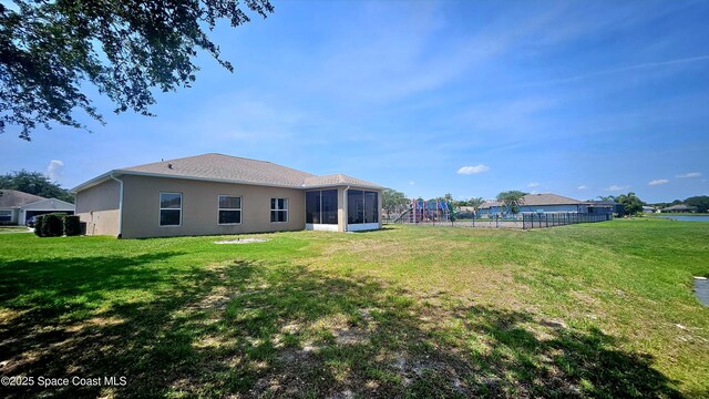 5290 Cinnamon Fern Blvd, Cocoa, FL 32927 - rear view of house with stucco siding and a sunroom