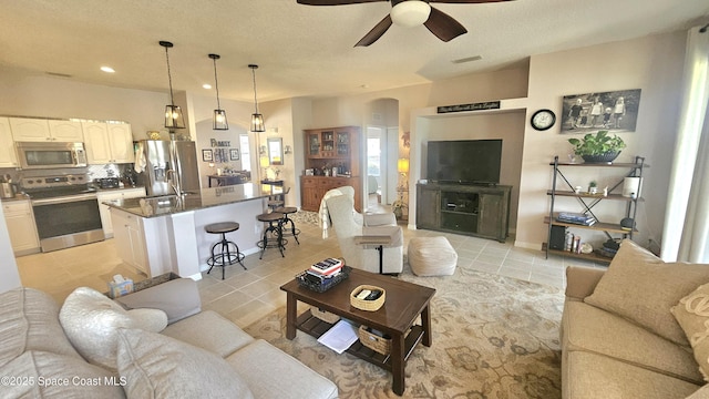 5290 Cinnamon Fern Blvd, Cocoa, FL 32927 - living area with light tile patterned flooring, ceiling fan, arched walkways, and recessed lighting