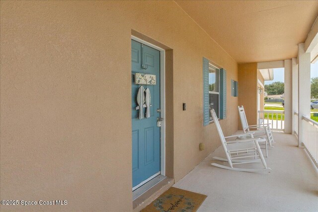 5290 Cinnamon Fern Blvd, Cocoa, FL 32927 - entrance to property with stucco siding and covered porch