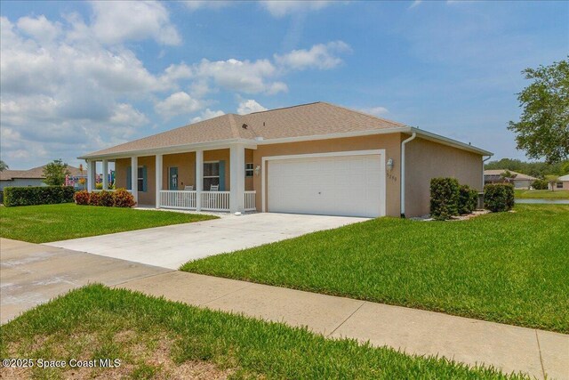 5290 Cinnamon Fern Blvd, Cocoa, FL 32927 - single story home with covered porch, an attached garage, a front lawn, concrete driveway, and stucco siding