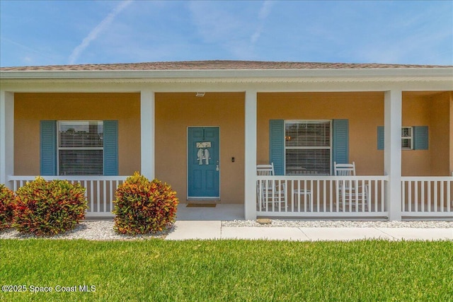 5290 Cinnamon Fern Blvd, Cocoa, FL 32927 - property entrance featuring a porch and stucco siding