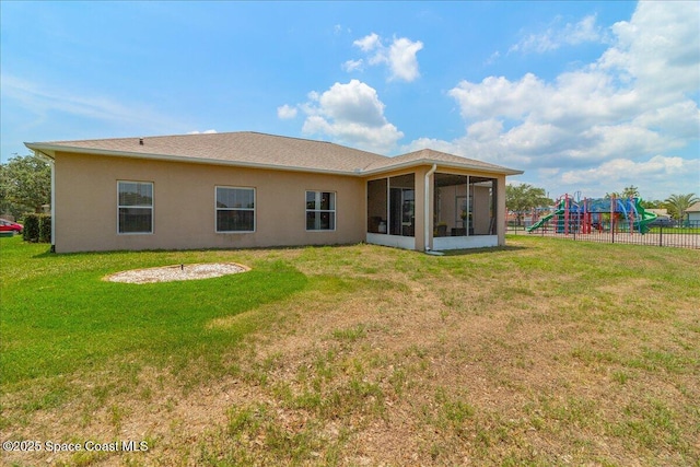 5290 Cinnamon Fern Blvd, Cocoa, FL 32927 - rear view of house featuring a playground, a sunroom, and stucco siding
