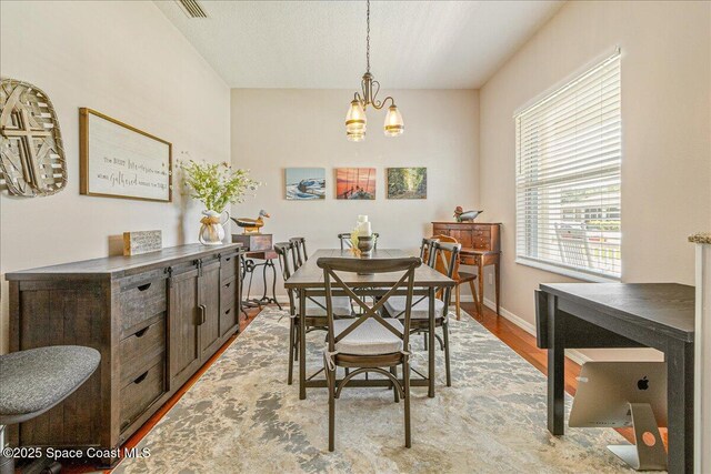 5290 Cinnamon Fern Blvd, Cocoa, FL 32927 - dining room with a chandelier, wood finished floors, and baseboards
