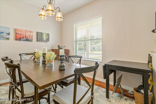 5290 Cinnamon Fern Blvd, Cocoa, FL 32927 - dining room with wood finished floors, baseboards, and a chandelier