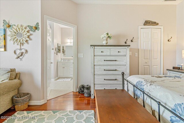 5290 Cinnamon Fern Blvd, Cocoa, FL 32927 - bedroom featuring wood finished floors, ensuite bath, and baseboards