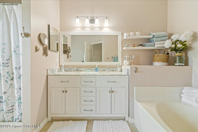 5290 Cinnamon Fern Blvd, Cocoa, FL 32927 - full bathroom featuring double vanity, curtained shower, a garden tub, and baseboards