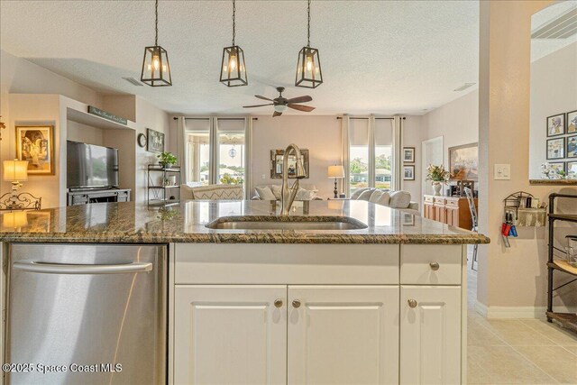 5290 Cinnamon Fern Blvd, Cocoa, FL 32927 - kitchen featuring a sink, stainless steel dishwasher, open floor plan, ceiling fan, and dark stone counters