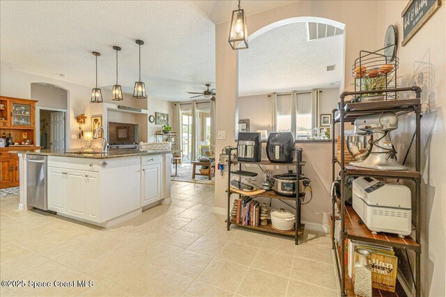 5290 Cinnamon Fern Blvd, Cocoa, FL 32927 - kitchen with arched walkways, a ceiling fan, a textured ceiling, white cabinets, and open floor plan