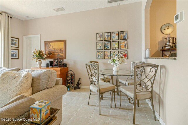 5290 Cinnamon Fern Blvd, Cocoa, FL 32927 - dining space featuring light tile patterned flooring, arched walkways, and baseboards