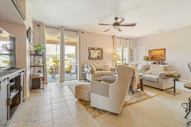 5290 Cinnamon Fern Blvd, Cocoa, FL 32927 - living area featuring a ceiling fan, a textured ceiling, and plenty of natural light