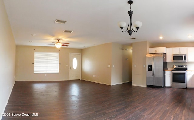 1581 Charles Blvd NE, Palm Bay, FL 32907 - kitchen featuring stainless steel appliances, dark wood-type flooring, white cabinets, baseboards, and recessed lighting