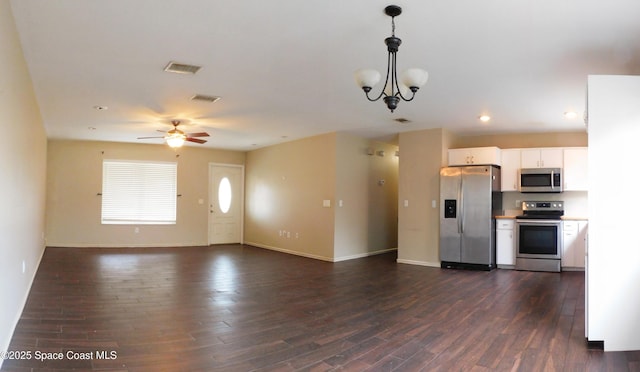 1581 Charles Blvd NE, Palm Bay, FL 32907 - kitchen with appliances with stainless steel finishes, dark wood-style flooring, white cabinets, decorative light fixtures, and recessed lighting