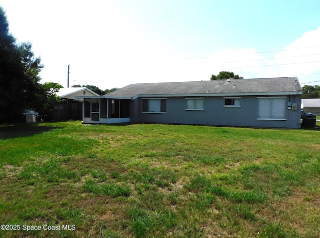 1581 Charles Blvd NE, Palm Bay, FL 32907 - rear view of house with a sunroom and a lawn