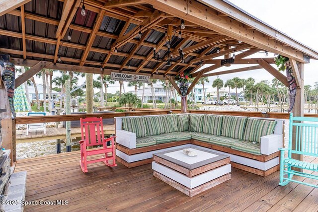 5250 Riveredge Dr, Titusville, FL 32780 - wooden deck with a gazebo, an outdoor hangout area, and a ceiling fan
