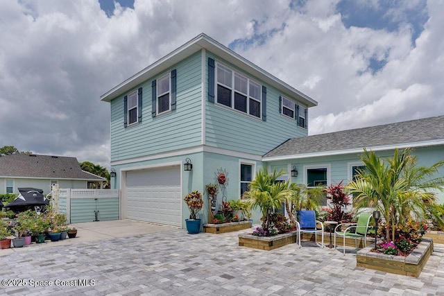 5250 Riveredge Dr, Titusville, FL 32780 - view of front of property featuring an attached garage, driveway, fence, and a gate