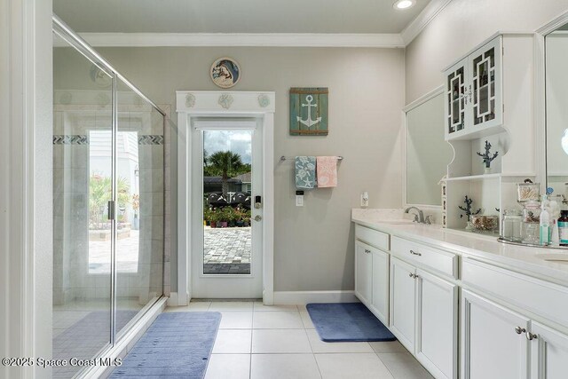 5250 Riveredge Dr, Titusville, FL 32780 - bathroom with tile patterned flooring, a stall shower, vanity, crown molding, and baseboards