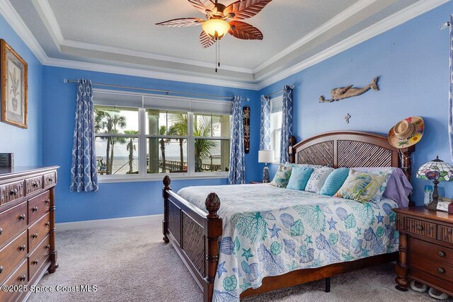 5250 Riveredge Dr, Titusville, FL 32780 - bedroom with carpet, crown molding, baseboards, a ceiling fan, and a tray ceiling