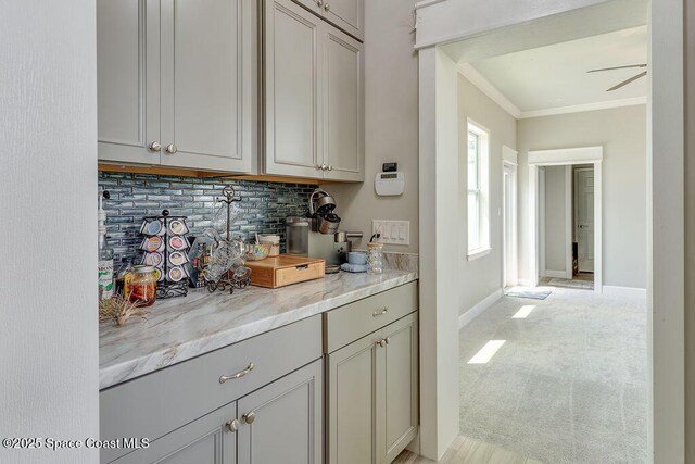 5250 Riveredge Dr, Titusville, FL 32780 - bar with tasteful backsplash, light carpet, ornamental molding, and baseboards