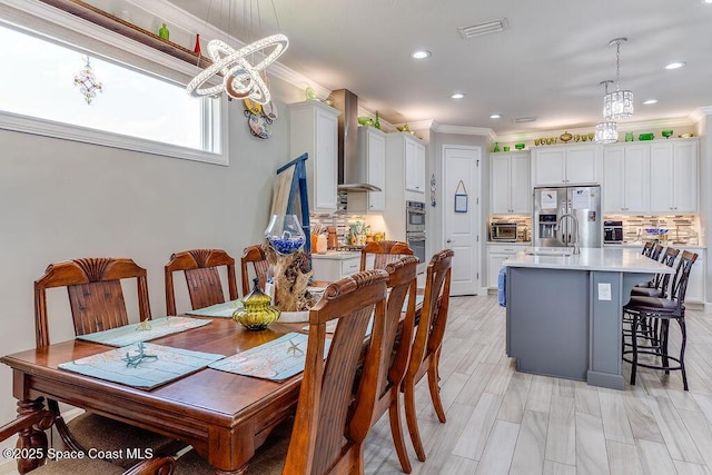 5250 Riveredge Dr, Titusville, FL 32780 - dining area with crown molding, recessed lighting, and a chandelier