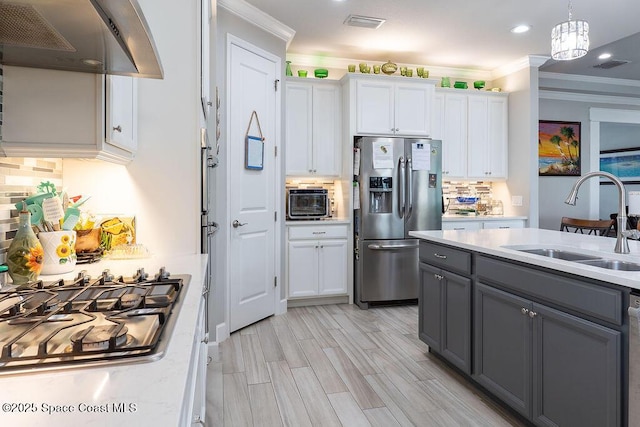 5250 Riveredge Dr, Titusville, FL 32780 - kitchen featuring appliances with stainless steel finishes, a sink, under cabinet range hood, gray cabinetry, and light countertops