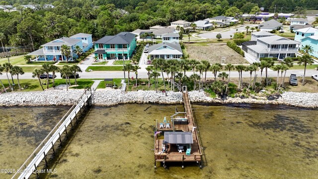 5250 Riveredge Dr, Titusville, FL 32780 - aerial view of residential area featuring a large body of water and a heavily wooded area