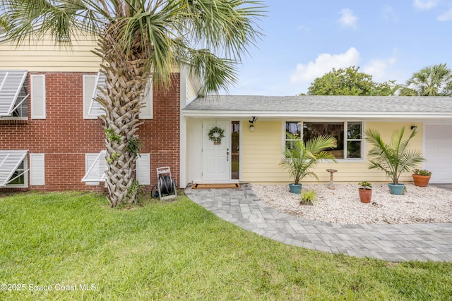 2007 Oak St, Melbourne Beach, FL 32951 - view of front of house with a front lawn, an attached garage, and roof with shingles