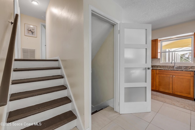 2007 Oak St, Melbourne Beach, FL 32951 - stairs with tile patterned flooring and a textured ceiling