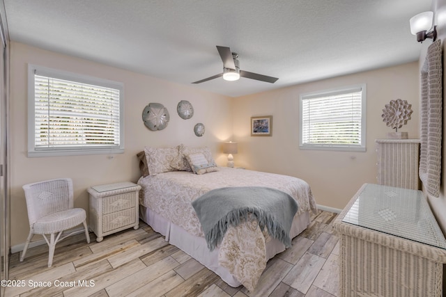 2007 Oak St, Melbourne Beach, FL 32951 - bedroom with light wood finished floors, baseboards, and ceiling fan