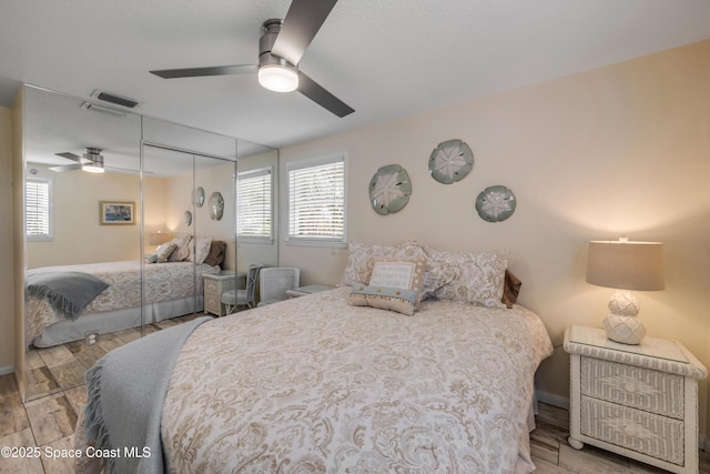 2007 Oak St, Melbourne Beach, FL 32951 - bedroom with multiple windows, wood finished floors, a closet, and a ceiling fan