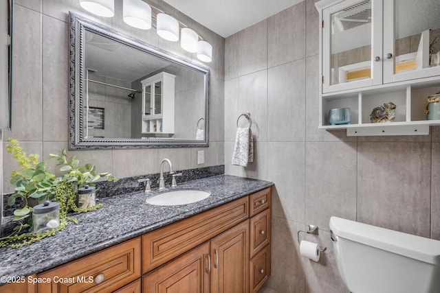 2007 Oak St, Melbourne Beach, FL 32951 - bathroom with tile walls, toilet, and vanity