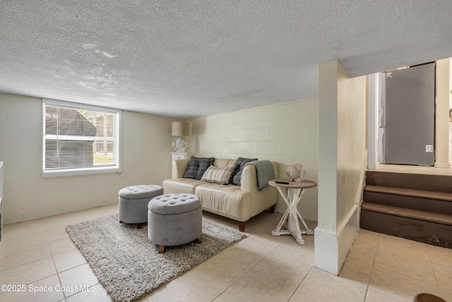 2007 Oak St, Melbourne Beach, FL 32951 - living room featuring concrete block wall, stairs, and a textured ceiling